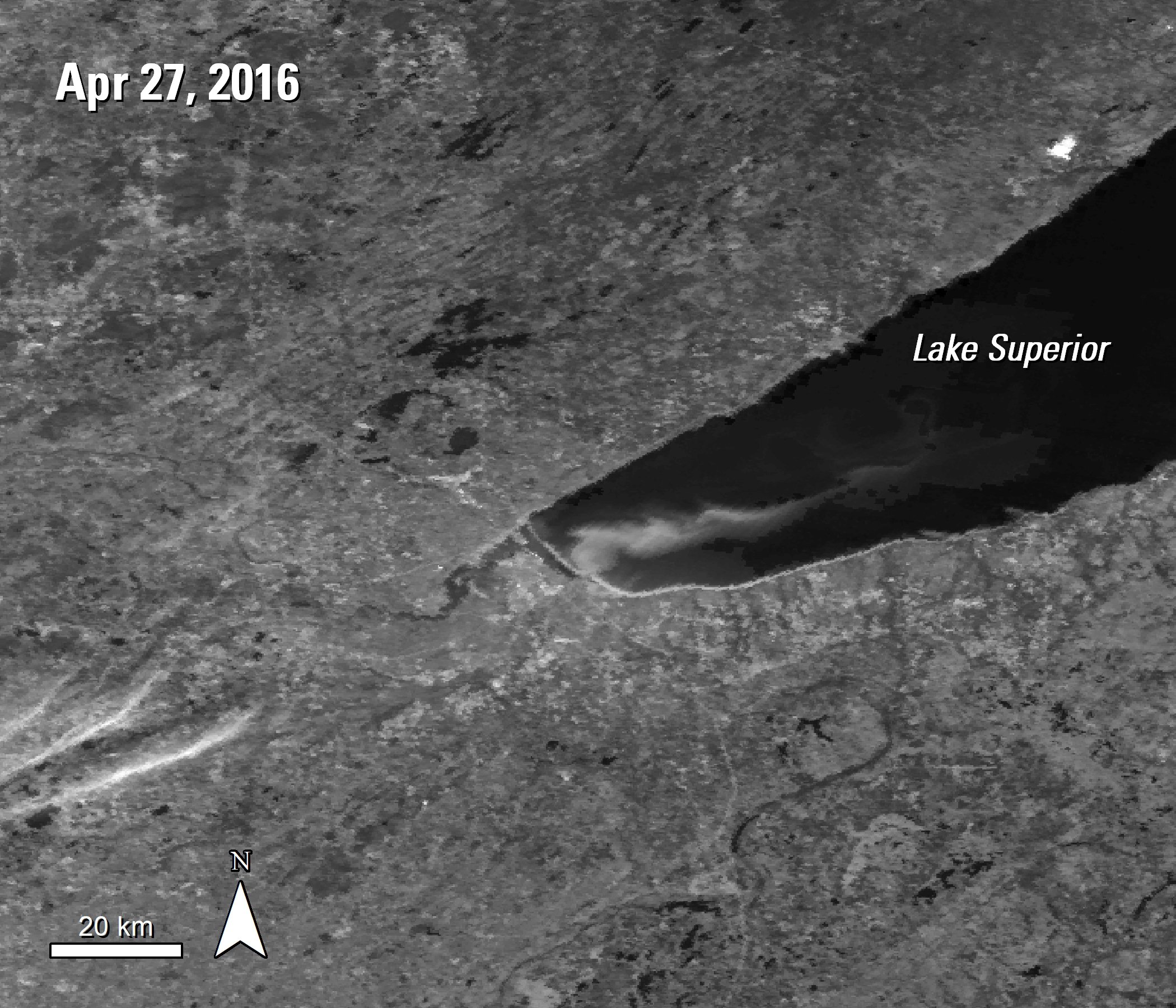 A black and white MODIS Surface Reflectance image over Lake Superior, Minnesota and Wisconsin, United States. A plume is visible over the bottom left portion of this section of the lake, acquired April 27, 2016.