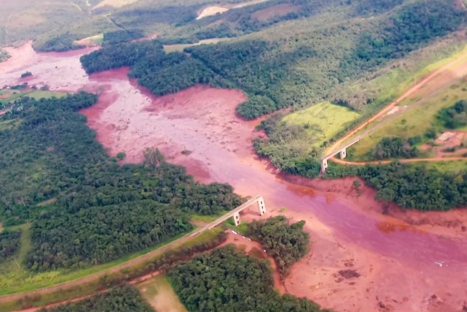 Public domain image of the aftermath of the Brumadinho dam collapse, with flooded areas and a bridge washed out.